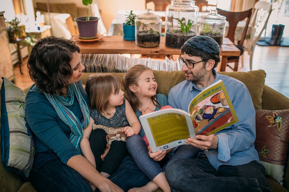 parents reading to children on a couch